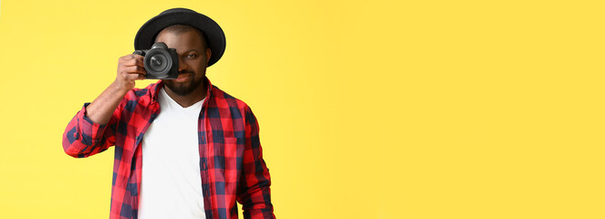 African-American photographer on yellow background with space for text