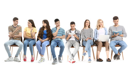 Fototapeta premium Many young people waiting in line on white background