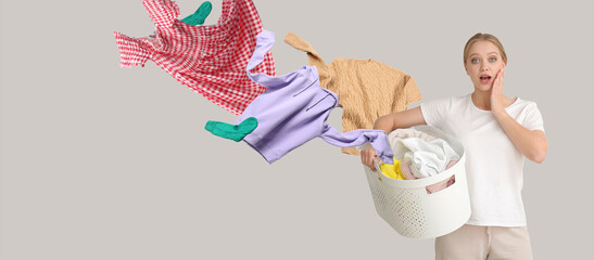 Shocked young woman with flying clothes and basket on grey background. Banner for design