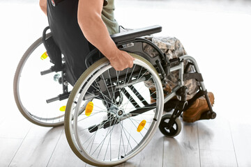 Young soldier in wheelchair at home