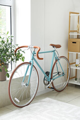 Fototapeta na wymiar Stylish bicycle near light wall in living room