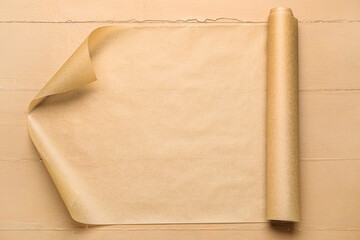 Sheet of baking paper on beige wooden background