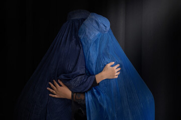 Muslim woman in Burka or Burqa, tradition cloths in Afghanistan and West Pakistan greeting and hugging to each other greeting to each other, Salam, As-salamu alaykum