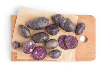 Board of raw purple potatoes on white background