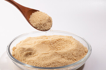 brown sugar heap and wooden spoon