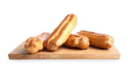 Wooden board with tasty eclairs isolated on white background