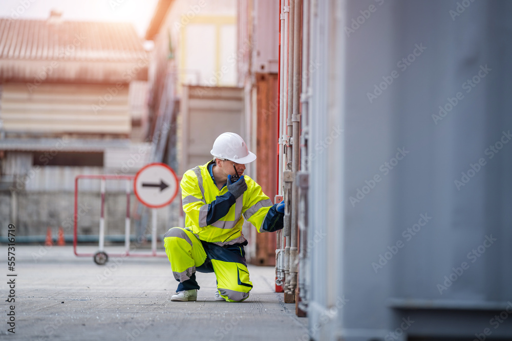 Poster Engineer using walkie talkie checking stock into container for loading,International shipping logistics.