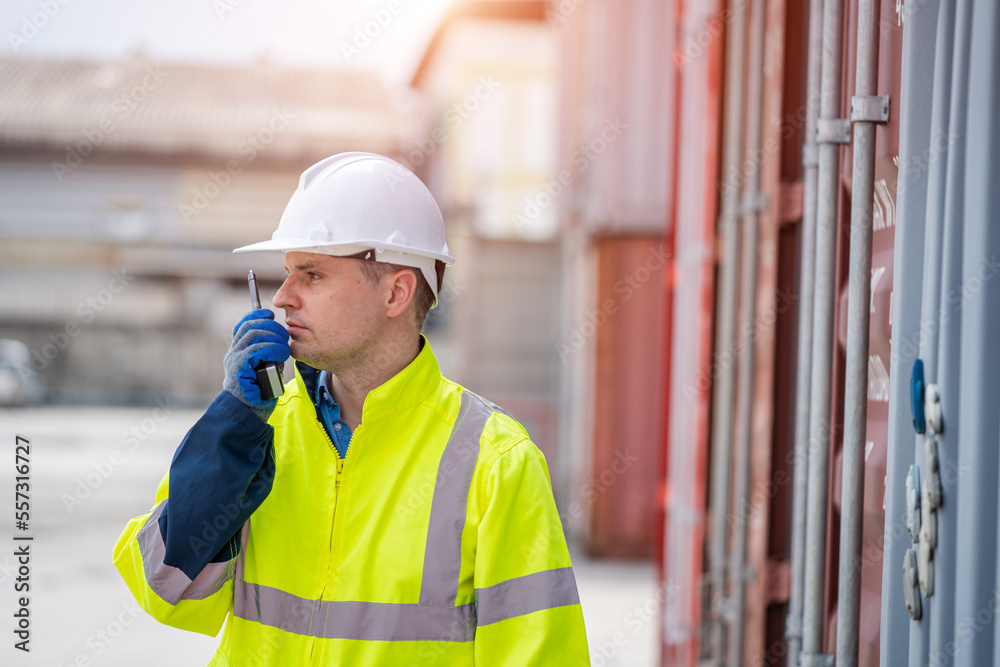 Poster technician working and inspecting cargo container in shipping yard,container shipping logistics conc