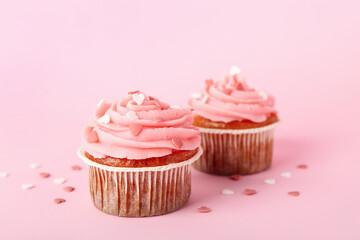 Tasty cupcakes for Valentine's Day on pink background