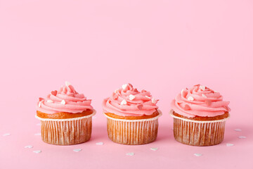 Tasty cupcakes for Valentine's Day on pink background