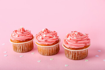 Tasty cupcakes for Valentine's Day on pink background
