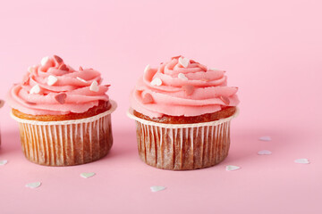 Tasty cupcakes for Valentine's Day on pink background