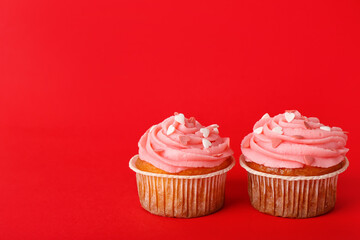 Tasty cupcakes for Valentine's Day on red background