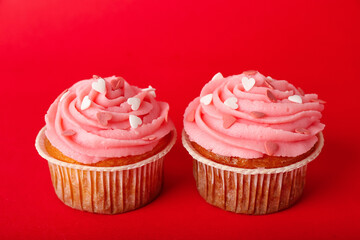 Tasty cupcakes for Valentine's Day on red background