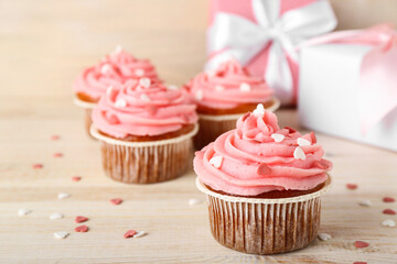 Tasty cupcake for Valentine's Day on wooden background, closeup