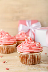 Tasty cupcake for Valentine's Day on wooden background, closeup