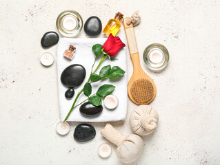 Spa composition for Valentine's Day with stones, rose and candles on white background