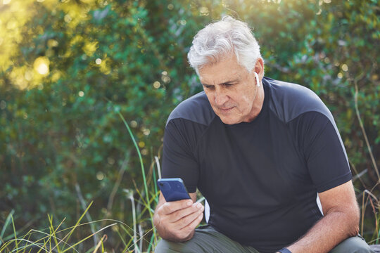 Fitness, Phone Or Old Man Streaming A Podcast, Radio Music Or Motivational Audio For Running Exercise Or Workout. Wellness, Relaxing Or Senior Person Listening To A Song In Headphones In Nature Park