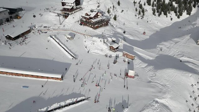 Ski Resort Belalp in Switzerland Aerial Shot. Mountain restaurants, gondola station, chairlift, skiers and ski slopes