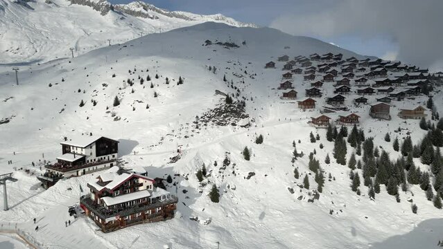 A ski resort in the mountains in Switzerland with vacation homes and ski lifts. It is Belalp in the canton of Valais
