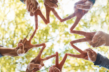 Hands, peace sign or team in nature with hope, support or team work for group vision, mission or goals success. Community, team building or people in partnership with motivation or teamwork in a park
