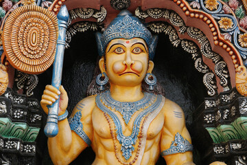 Hanuman with a fan close-up. Divine hero of the Ramayana on the wall of a Hindu temple in Puri.