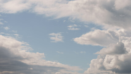 Fototapeta na wymiar White cumulus clouds on a blue sky