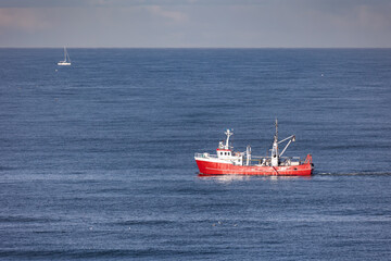 A red cutter the North sea close to Egmond aan Zee, Netherlands