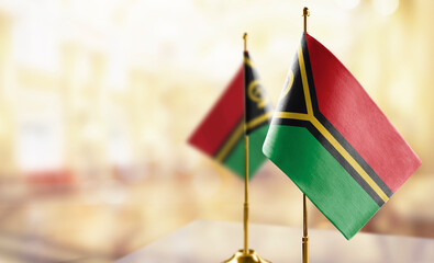 Small flags of the Vanuatu on an abstract blurry background