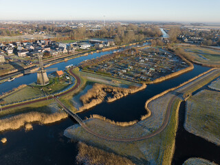 Strijkmolen E, Ouddorp, Alkmaar, North Holland,The Netherlands. Oak octagonal polder mill from 1630. Ironing mills do not drain polders, grind the water from one reservoir to the other. Winter aerial.