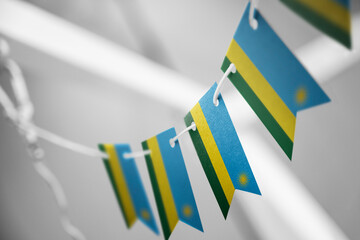 A garland of Rwanda national flags on an abstract blurred background