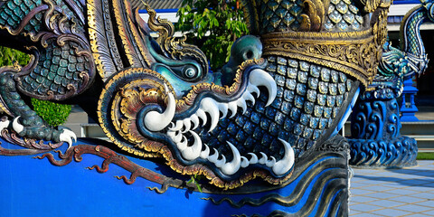 Obraz premium Detail of dragon in Wat Rong Suea Ten, Temple of the Dancing Tiger, in the blue buddhist temple -Chiang Rai-Thailand