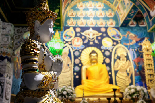 statue of buddha, in buddhist temple at night time 