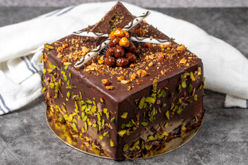 Chocolate and pistachio cake on a dark background. Birthday or celebration cake. close up