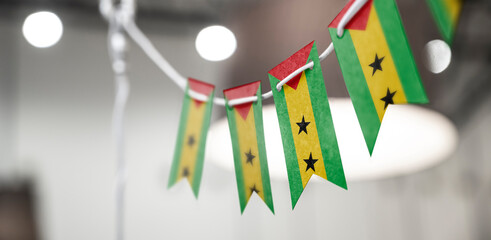 A garland of Sao Tome and Principe national flags on an abstract blurred background