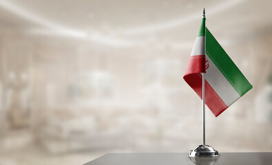 A small Iran flag on an abstract blurry background
