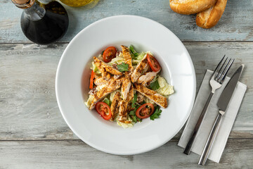 Fresh Mediterranean salad with grilled chicken breast. top view
