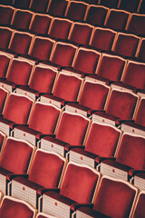 Indoor concert background abstract seats chairs seating in concert hall watching performing music instruments in symphony orchestra