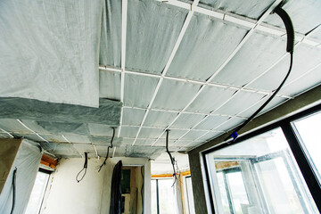 Insulation and ceiling lining with heat-insulating and energy-saving materials. Fragment of the...