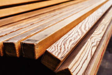 Fragment of a wooden bench made of pine timber. Construction and installation of outdoor furniture in a garden or city park. Close-up