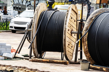Electric cable on a wooden reel located at a construction site. Construction and installation of...