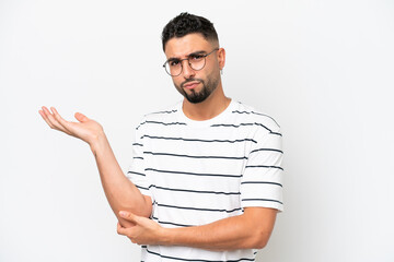 Young Arab handsome man isolated on white background having doubts