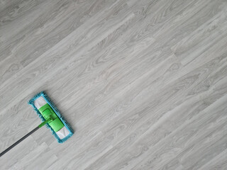 Washes floor in office or at home closeup
