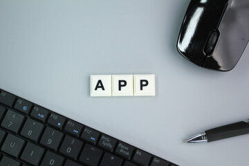 laptop keyboard, mouse and pen with the word App. application or Android concept - Powered by Adobe