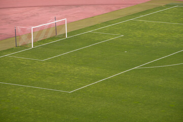 Sports stadium with soccer goal. Football or soccer goal post on a green grass pitch on stadium.