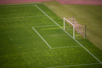 Sports stadium with soccer goal. Football or soccer goal post on a green grass pitch on stadium.