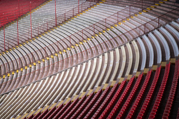 Row of Empty seats of tribune on sport stadium. Concept of fans. Chairs for audience. Empty seats, modern stadium.