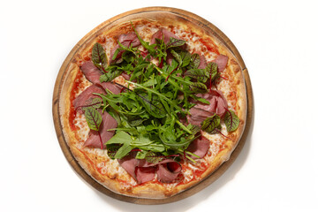 pizza with ham and basil on desk on white background