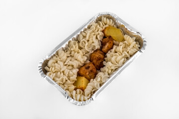 close-up of a homemade lunch of pasta and bbq in a lunchbox