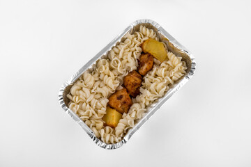 close-up of a homemade lunch of pasta and bbq in a lunchbox